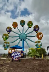 The Whirling Wonder Ferris Wheel at Morgan’s Wonderland, featuring colorful gondolas with accessible seating.